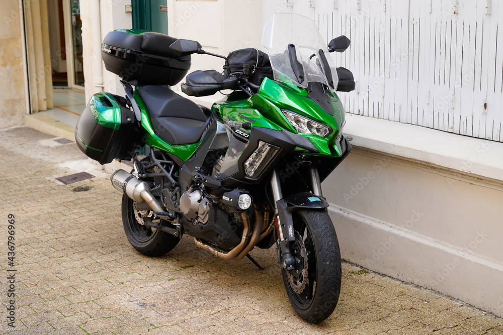 Kawasaki Versys 1000 green trail gt motorcycle parked in street city Stock  Photo | Adobe Stock