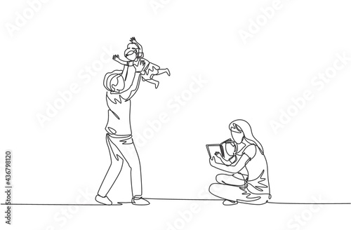 One single line drawing of young mother sitting on floor and reading book to son while father playing with daughter vector illustration. Happy family parenting concept. Continuous line draw design
