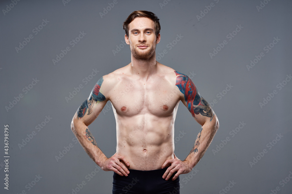 sporty man pumped up press acting out on his arms cropped view gray background sporty man pumped up press acting out on his arms cropped view gray background