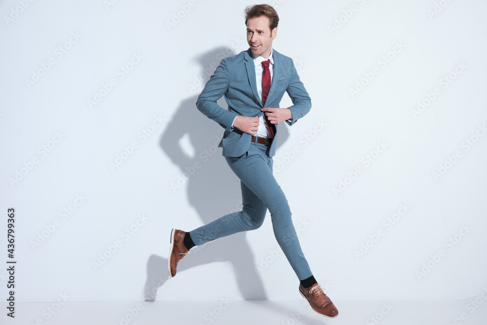 dynamic businessman jumping and unbuttoning blue suit dynamic businessman jumping and unbuttoning blue suit