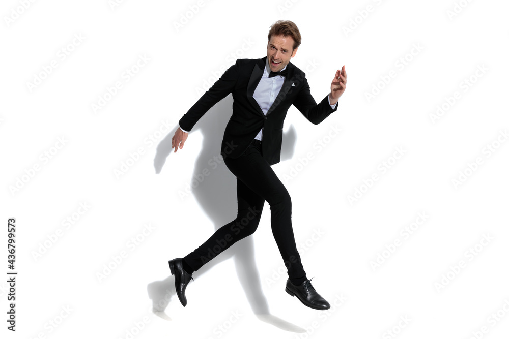 sexy businessman full of joy is jumping in the air