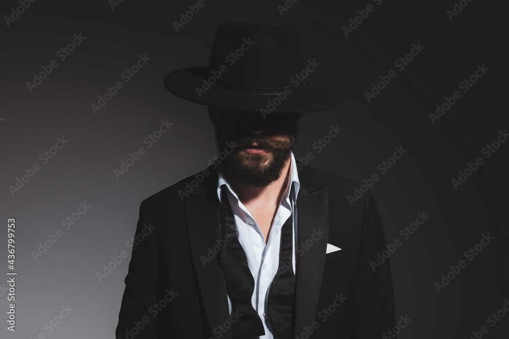 portrait of a mysterious businessman wearing a black hat