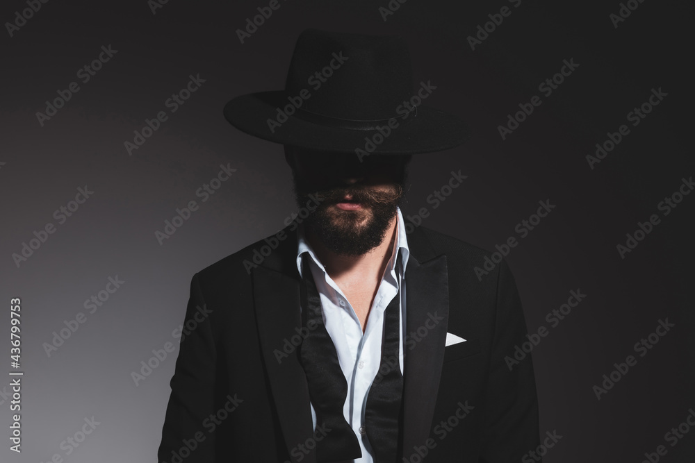 portrait of a mysterious businessman wearing a black hat portrait of a mysterious businessman wearing a black hat