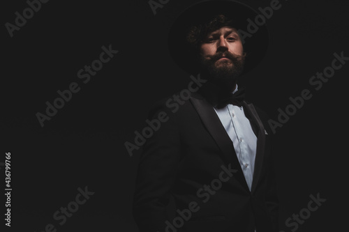 handsome businessman posing with arrogance in his cool tuxedo