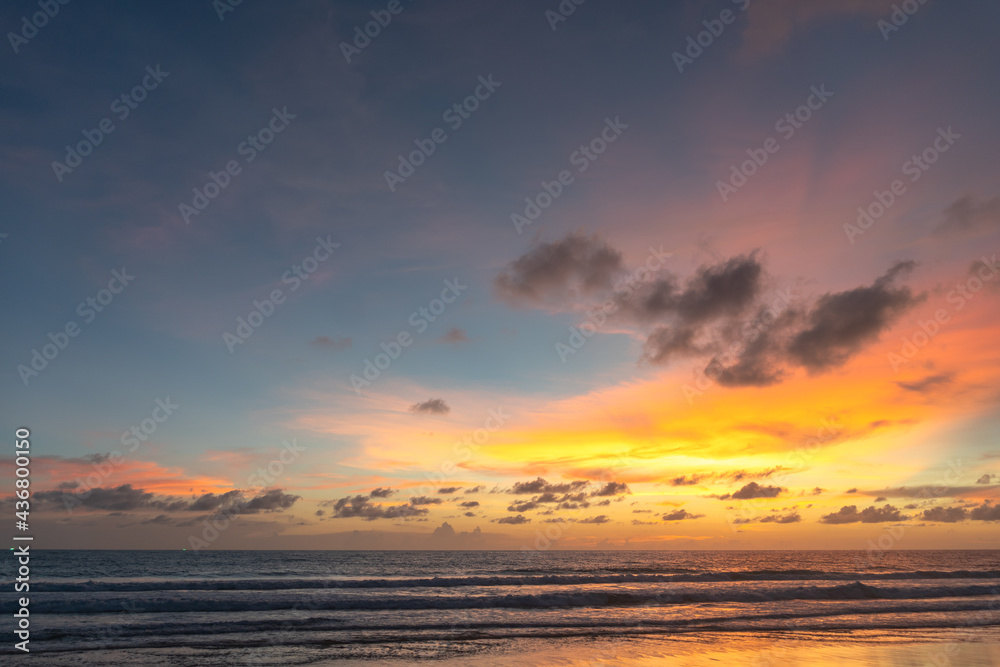 Obraz premium Majestic sunset or sunrise landscape Amazing light of nature cloudscape sky and Clouds moving away rolling .Beautiful Phuket beach is a famous tourist destination in Andaman sea summer. 