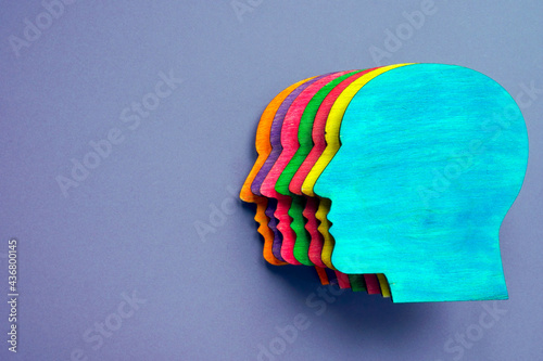 Wooden head with different colors as symbol of diversity and inclusion. photo