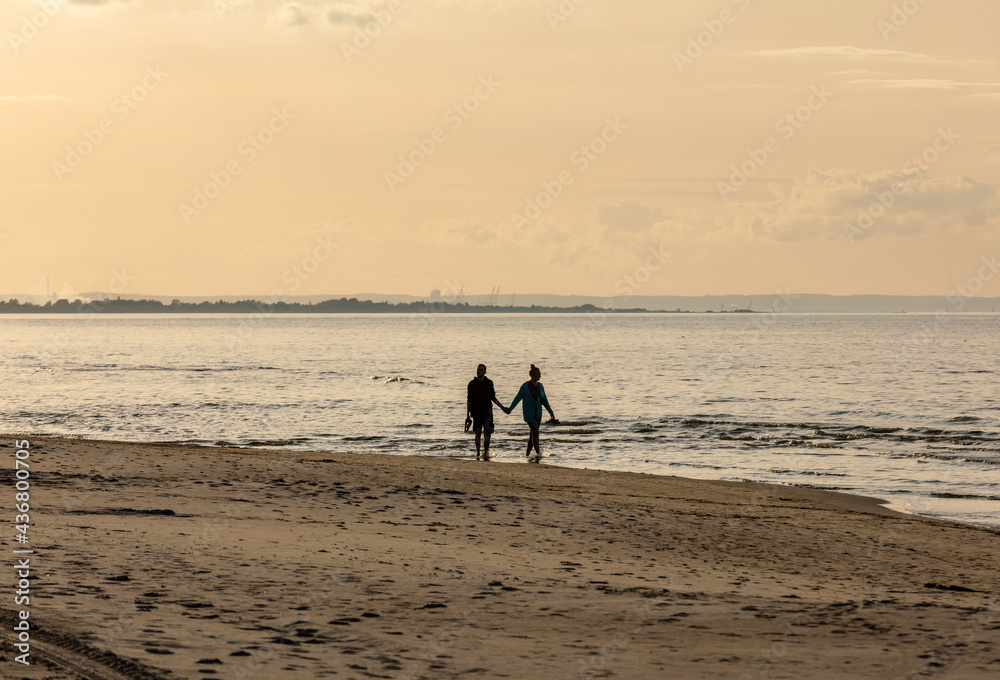 Romantic walk of a couple in love on the beach in Stegna, Pomerania. Poland Romantic walk of a couple in love on the beach in Stegna, Pomerania. Poland