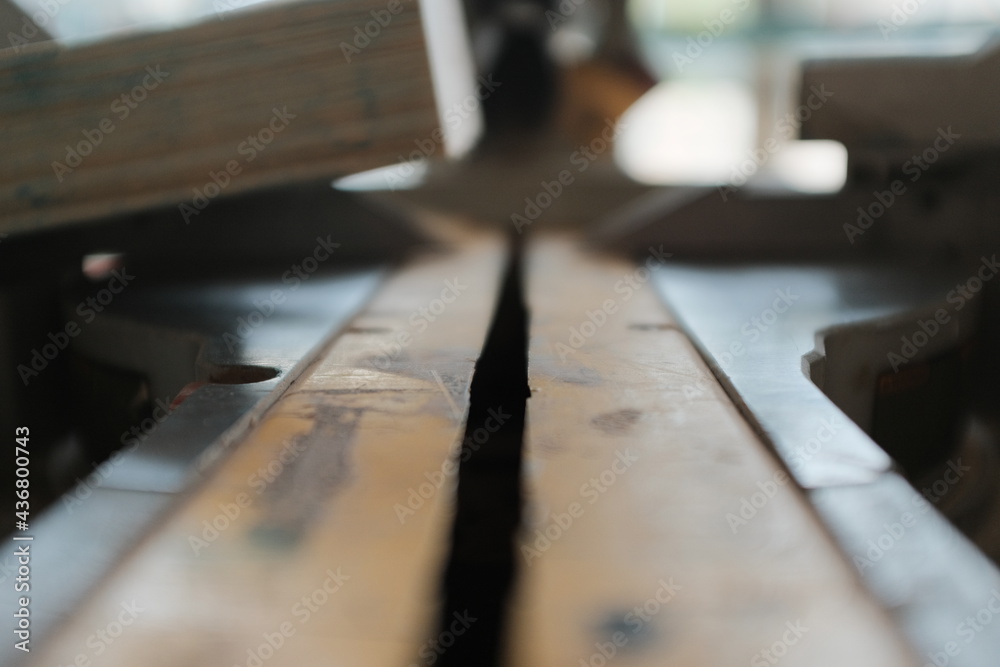 close up of a saw cutting wood close up of a saw cutting wood