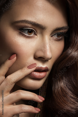 Beauty Model with Nails Manicure and Beige Lipstick Makeup. Beautiful Girl showing Nail Polish Cosmetic. Woman Make up Face Profile View Closeup