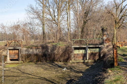 Robecco sul Naviglio ( MI ), Italy - April 01, 2021: An old dam at Robecco sul Naviglio, Milano, Lombardy, Italy photo