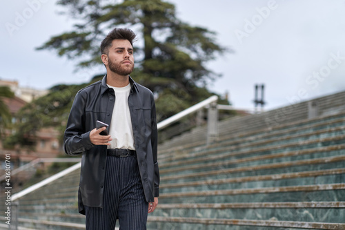 Caucasian men with beard, with smartphone in hand