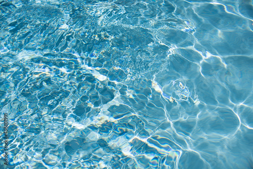 Water in swimming pool, background with high resolution. Wave abstract or rippled water texture.
