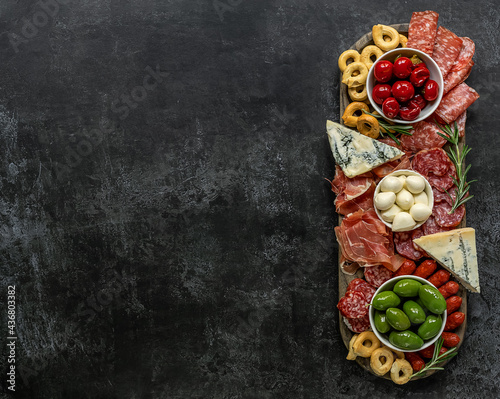 Italian antipasti or charcuterie board. Assortments of meat and cheese snacks. copy space, view over above photo