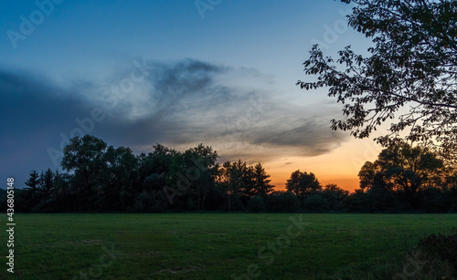 Sunset over the edge of a forest