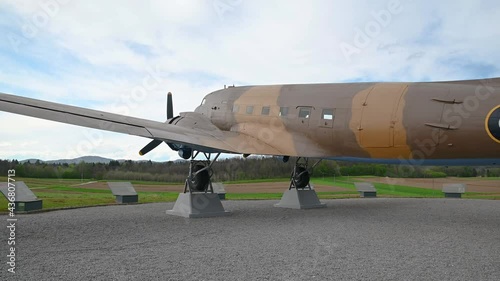 Decommissioned aeroplane, a memorial to partizans and their help to Allied air forces during WWII. Aircraft exhibit in Slovenia. Wide angle, right pan photo