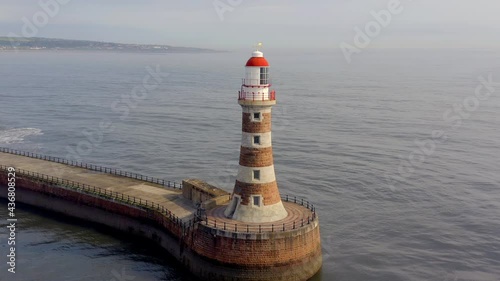 A Lighthouse and Pier in the Early Morning