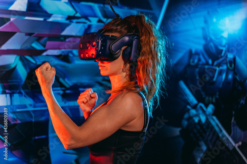 Virtual reality. A woman plays games in a virtual reality helmet.