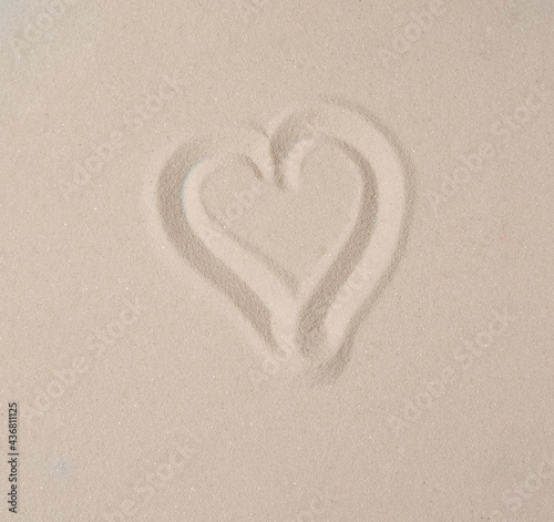 Heart drawn in sand. Summer beach concept.