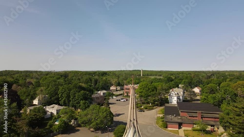 Aerial descent reveal of a church surrounded by trees in Weymouth, Massachusetts photo