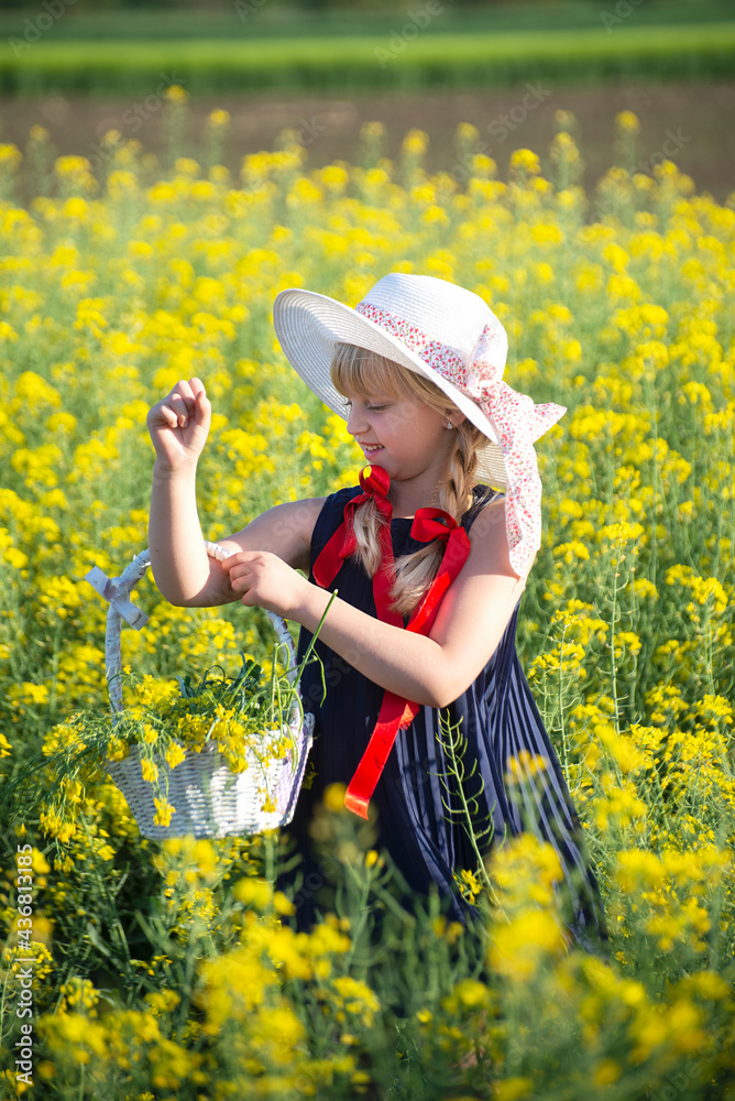 Little blonde girl is playing in a meadow flower Little blonde girl is playing in a meadow flower