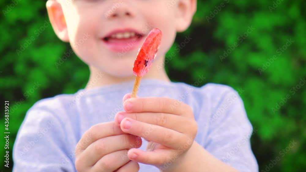 The child is eating a lollipop. Selective focus. The child is eating a lollipop. Selective focus.