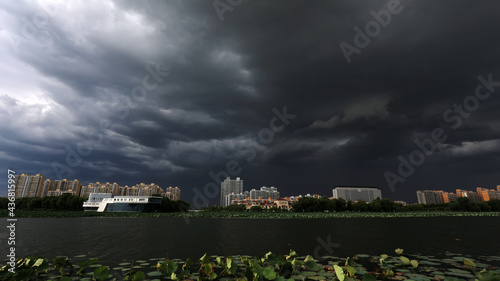 Urban architectural landscape shrouded by dark clouds, North China