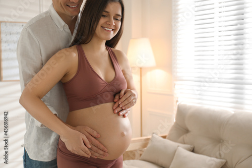 Man touching his pregnant wife's belly at home. Space for text Free Download Man touching his pregnant wife's belly at home. Space for text - GFXLoad