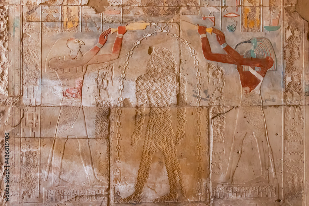 Ancient Egyptian hieroglyphs depicting mythological gods on the walls ...
