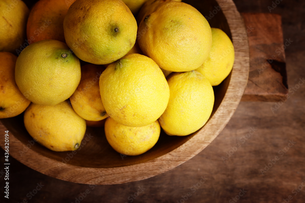Image of group of fresh lemons over old vintage wooden table