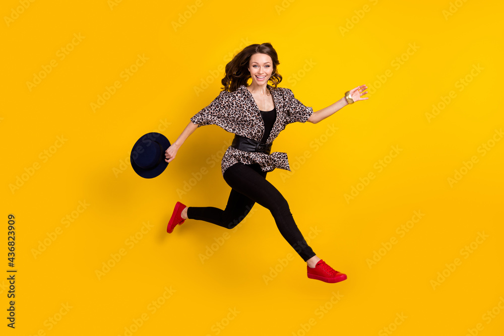 Full size profile side photo of active charming woman run jump up empty space sale isolated on yellow color background Full size profile side photo of active charming woman run jump up empty space sale isolated on yellow color background