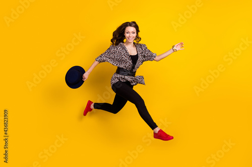 Full size profile side photo of active charming woman run jump up empty space sale isolated on yellow color background