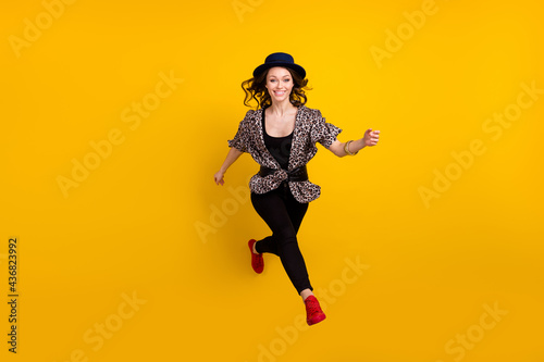 Full body photo of happy nice active young woman jump up runner sale isolated on yellow color background