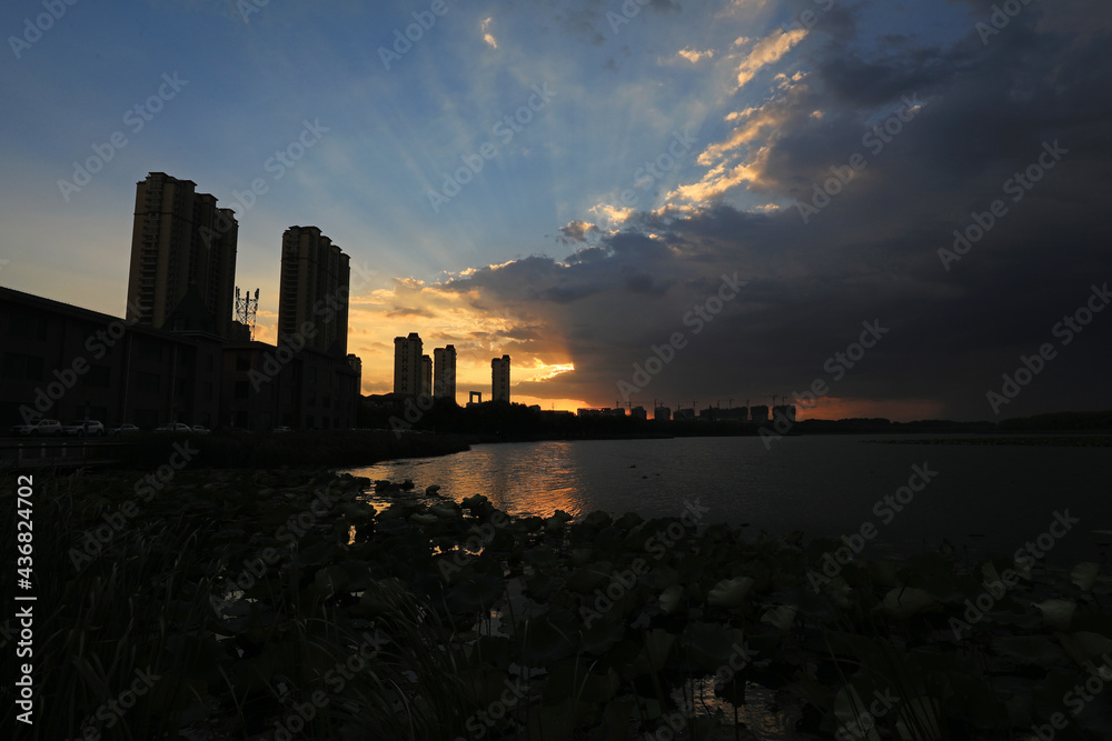 In the evening, the architectural scenery of the city is near the water, North China In the evening, the architectural scenery of the city is near the water, North China