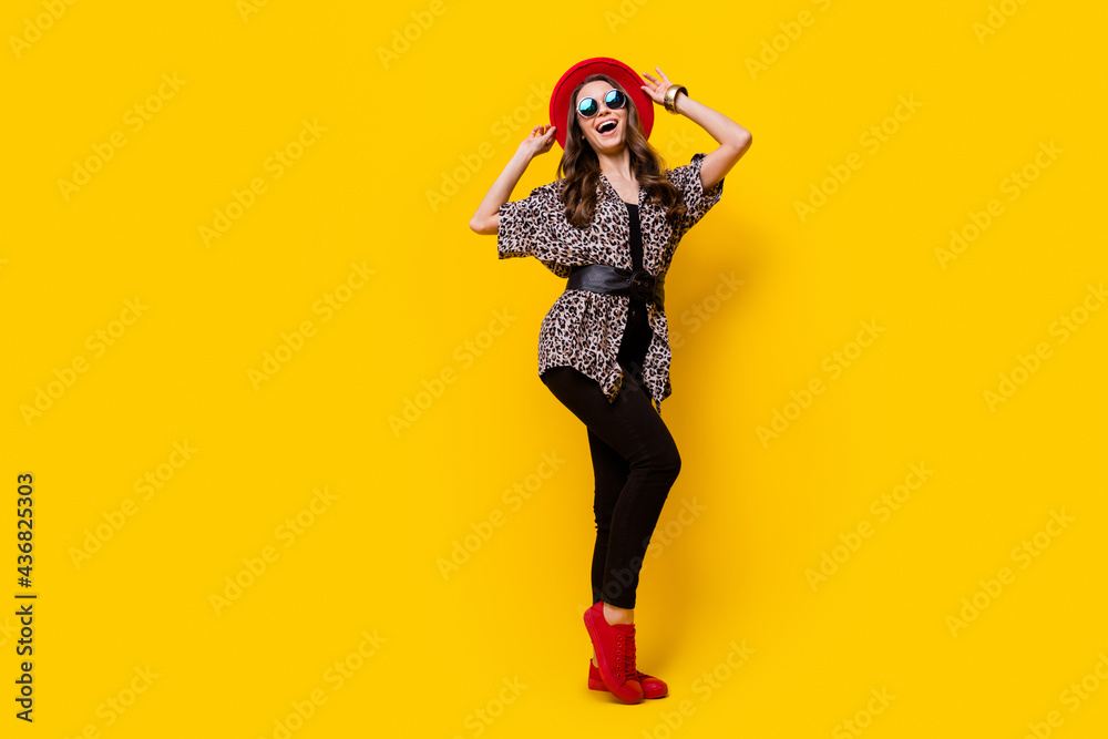 Full length photo of pretty nice stunning young woman wear cool sunglass glamour isolated on yellow color background Full length photo of pretty nice stunning young woman wear cool sunglass glamour isolated on yellow color background