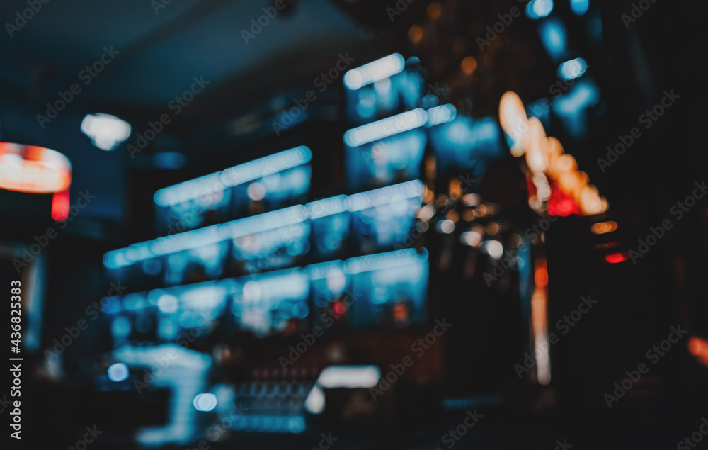 Blurred bar shelves and bar counter with many bottles - obrazy, fototapety, plakaty 