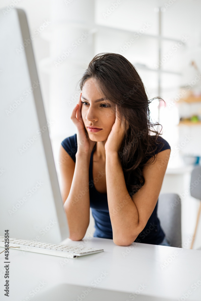 Obraz premium Young and beautiful businesswoman, student tired from work in home office