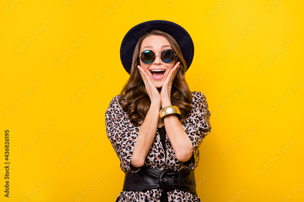 Photo of amazed excited young woman hold hands cheeks shock sale isolated on yellow color background
