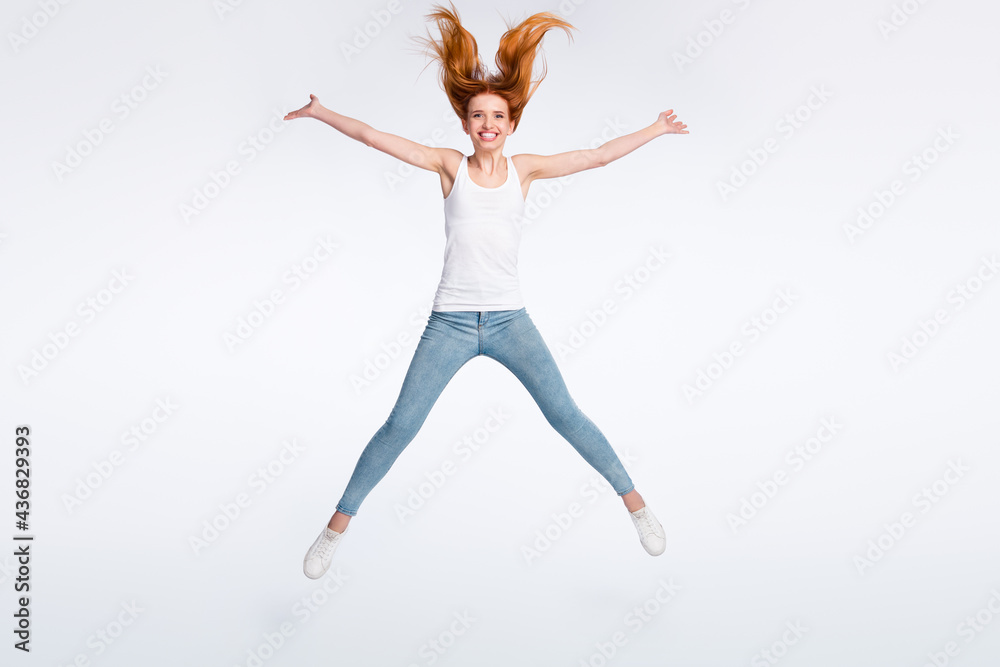 Full size photo of funny positive red hairdo lady jump wear white top jeans isolated on bright color background