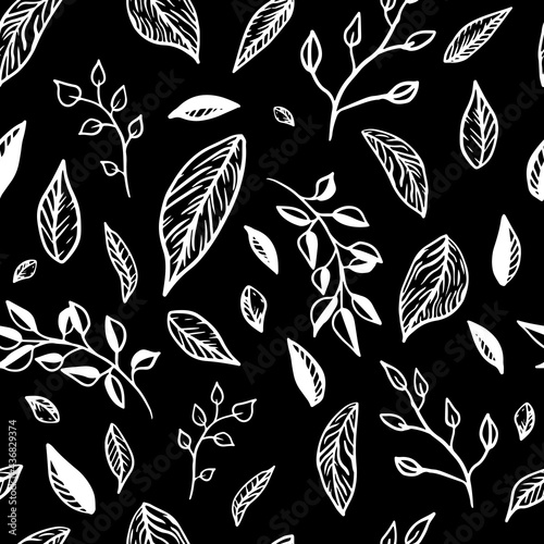 Seamless pattern of leaves and twigs on a black background. Forest, graphic print for textiles in doodle style. Vector illustration.