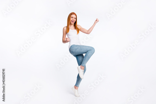 Full size photo of hooray nice red hairdo lady hands fists wear white top jeans isolated on bright color background