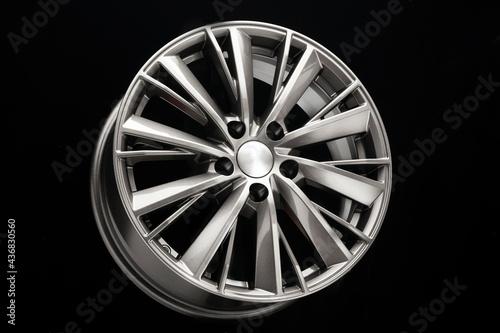 new beautiful silver alloy wheel on a black background. close-up