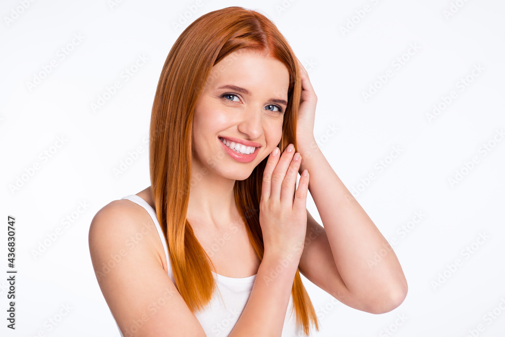 Photo of young cheerful girl happy positive smile hand touch ginger hair isolated over grey color background Photo of young cheerful girl happy positive smile hand touch ginger hair isolated over grey color background