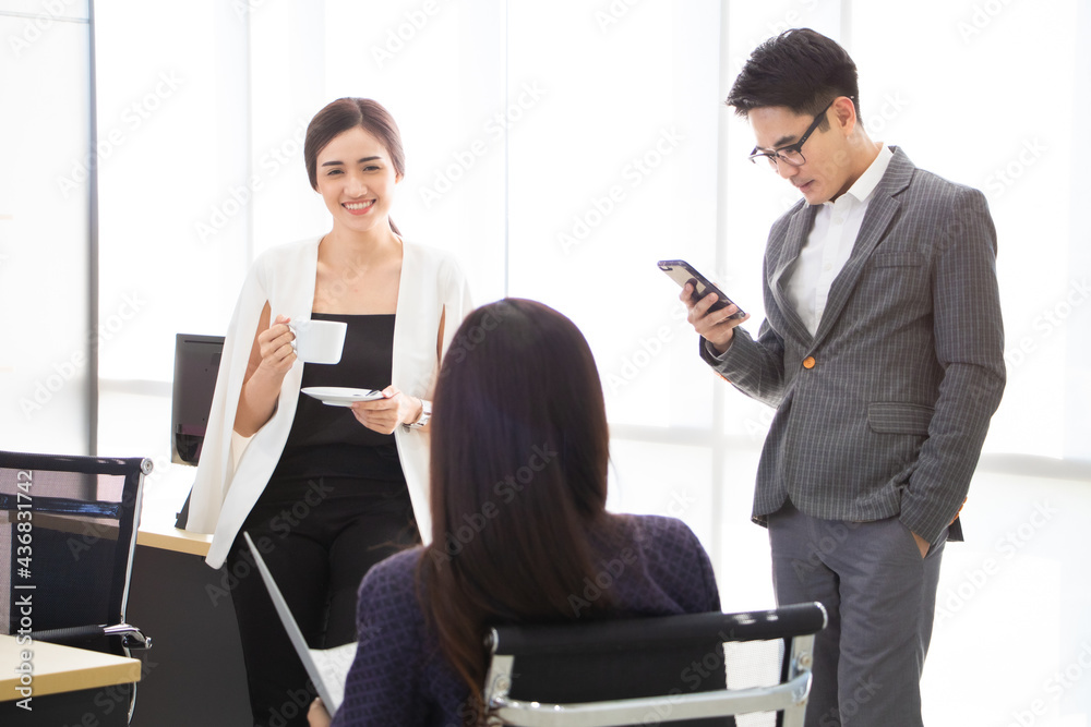 Fototapeta premium Asian young male and female have a casual and free style meeting, drinking coffee and checking information on phone.