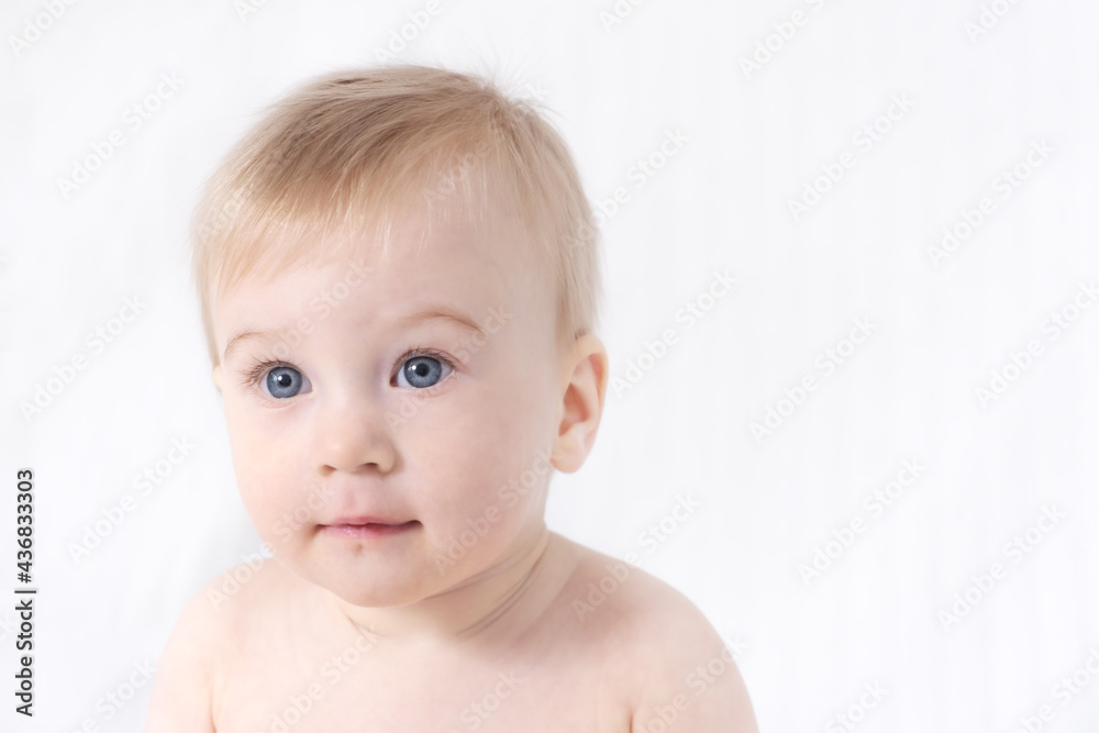 Close-up of cute little adorable funny caucasian topless baby girl or boy on white, light grey background.Healthy skin.Happy childhood concept, copy space for text Close-up of cute little adorable funny caucasian topless baby girl or boy on white, light grey background.Healthy skin.Happy childhood concept, copy space for text