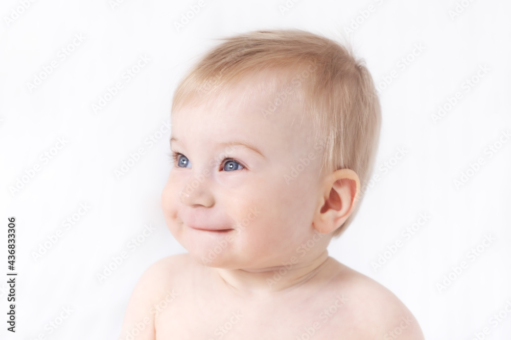 Close-up of cute little adorable funny smiling caucasian topless baby girl or boy on white, light grey background.Healthy skin.Baby care, happy childhood concept Close-up of cute little adorable funny smiling caucasian topless baby girl or boy on white, light grey background.Healthy skin.Baby care, happy childhood concept