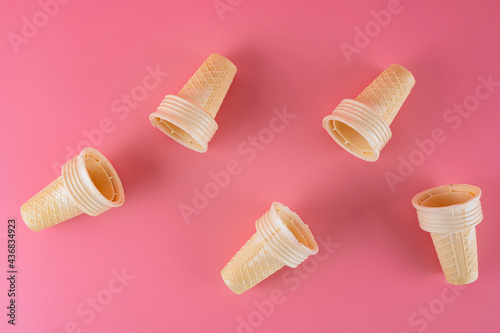 Ice cream cone on pink faded pastel color background