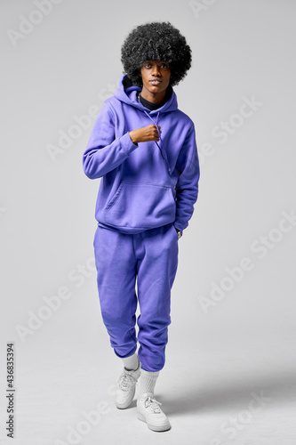 Young black man wear of blue set of tracksuit isolated on gray background