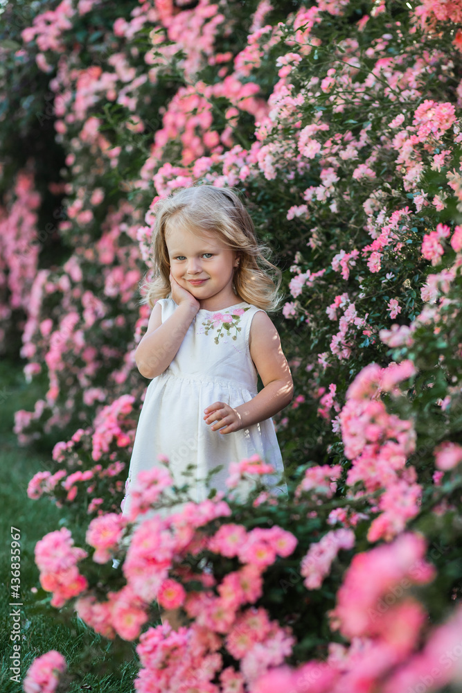 little girl in the flower garden little girl in the flower garden