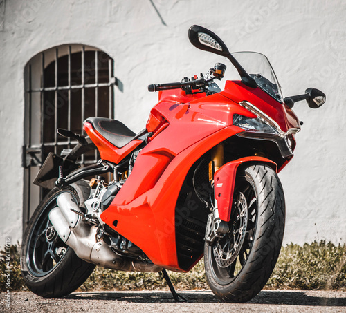red motorcycle parked on a street
