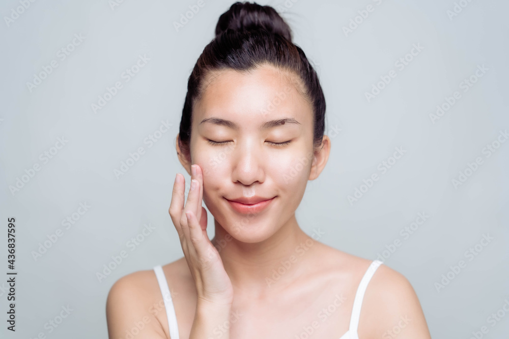 Beautiful young asian woman with clean fresh skin on white background. Asian women portrait. Beautiful young asian woman with clean fresh skin on white background. Asian women portrait.
